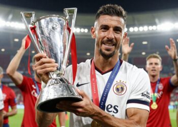 Bruno Fernandes holding a Player of the Season trophy.