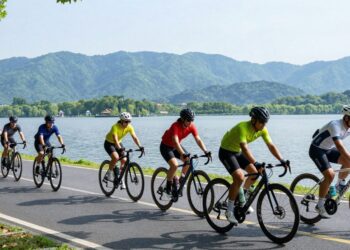 Cyclists ride bikes near Dal Lake for Cyclothon 2026.
