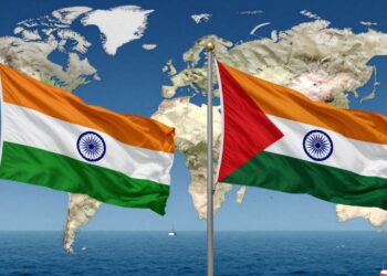 India and UAE flags with global map backdrop.