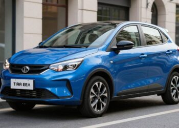 Blue compact hatchback car parked on a city street, shown from the front‑left angle.