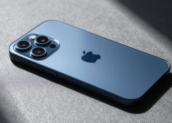 iPhone 17 Pro Max deep blue, sunlight glinting off display.