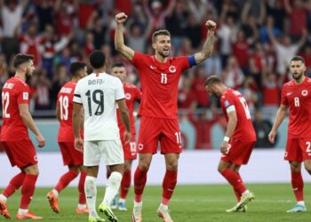 Canadian soccer player celebrates goal against Bosnia and Herzegovina.
