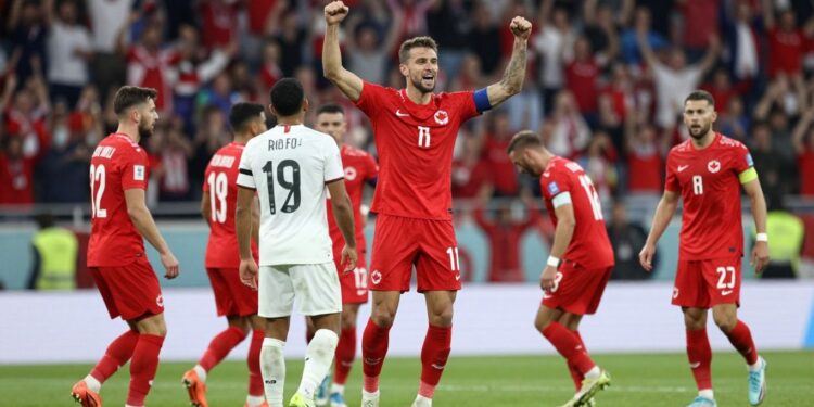 Canadian soccer player celebrates goal against Bosnia and Herzegovina.