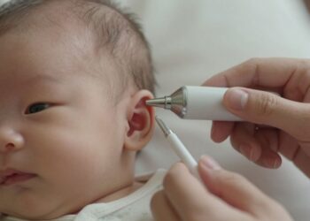 Newborn baby's ear during a hearing screening.